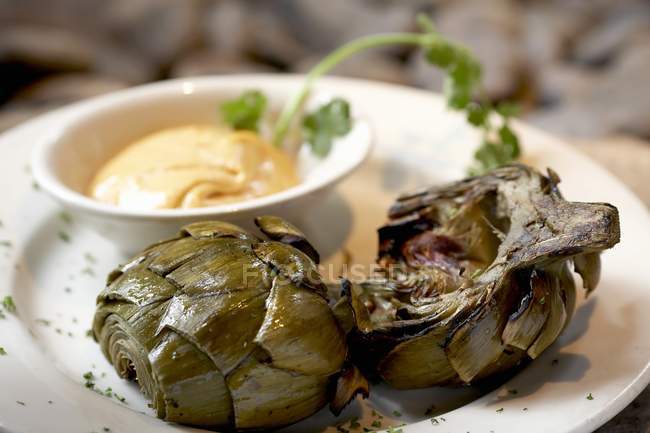 Roasted Artichokes with Garlic Aioli on white plate — Stock Photo
