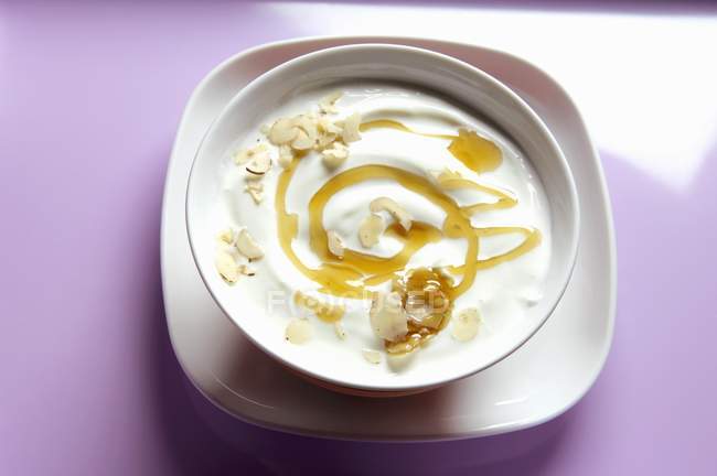 Yogurt with honey and hazelnuts — Stock Photo