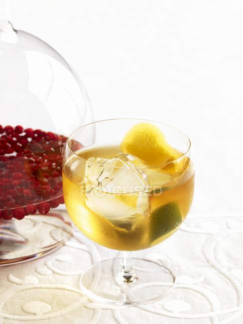 Lime  juice with a pitcher of lingonberry vodka — Stock Photo