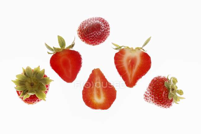 Slices of strawberries with stalks — Stock Photo