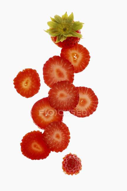 Slices of strawberries with stalk — Stock Photo