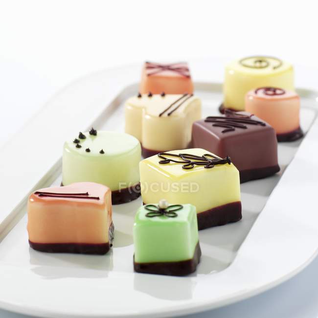 Petit fours on serving plate — Stock Photo