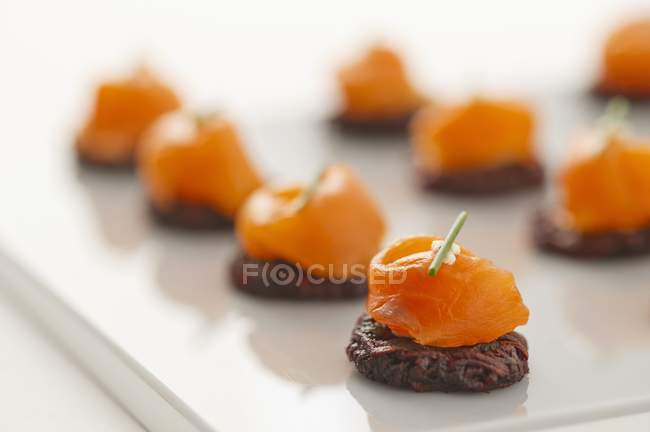 Smoked salmon on beetroot potato cakes — Stock Photo