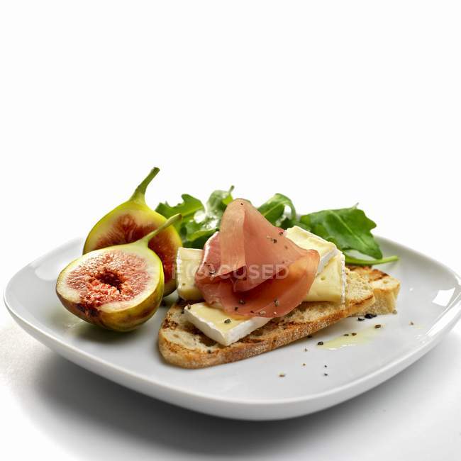 Italian dry cured ham over white — Stock Photo