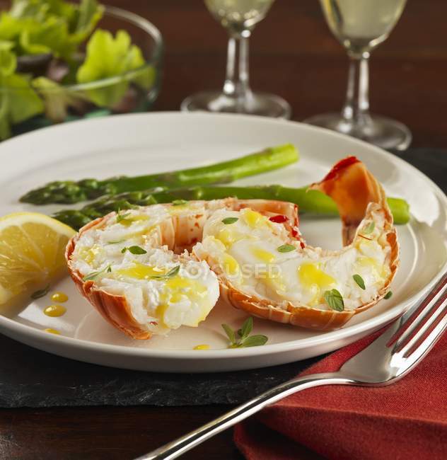 Closeup view of lobster tails with lemon butter and thyme — Stock Photo
