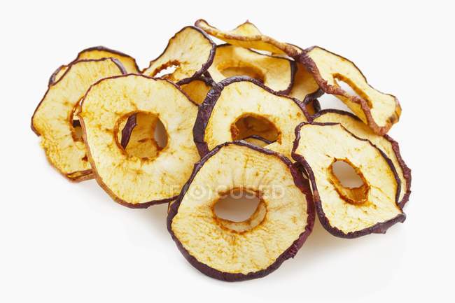 Closeup view of dried apple rings on white background — Stock Photo