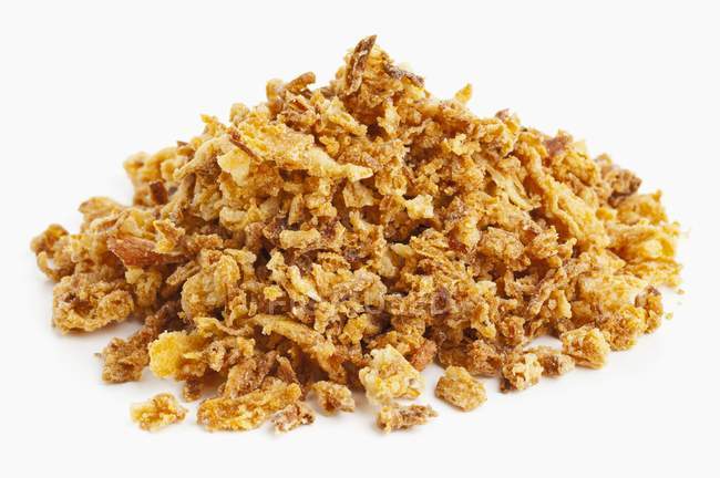 A pile of crispy fried onions  on white surface — Stock Photo