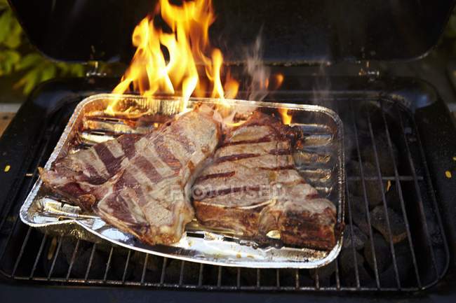 T-bone steak in tray — Stock Photo
