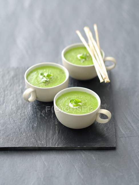 Cream of pea soup with grissini — Stock Photo