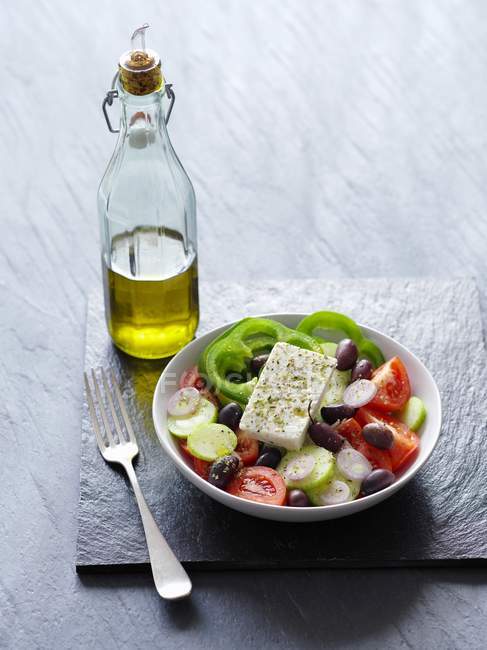 Greek salad and oil — Stock Photo