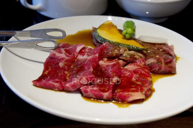 Wagyu meat marinated in soy sauce and sake with pumpkin, ocra and onion — Stock Photo