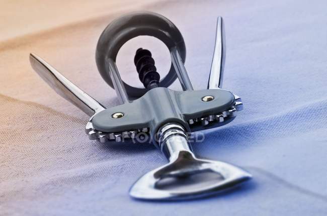 Closeup view of one corkscrew on blue cloth — Stock Photo