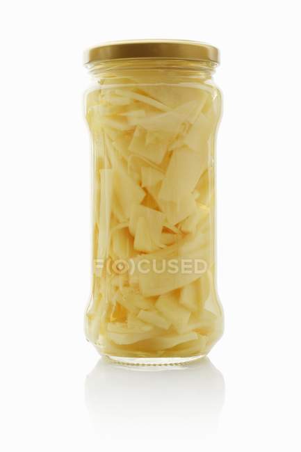 Bamboo shoots in a screw-top jar on white background — Stock Photo