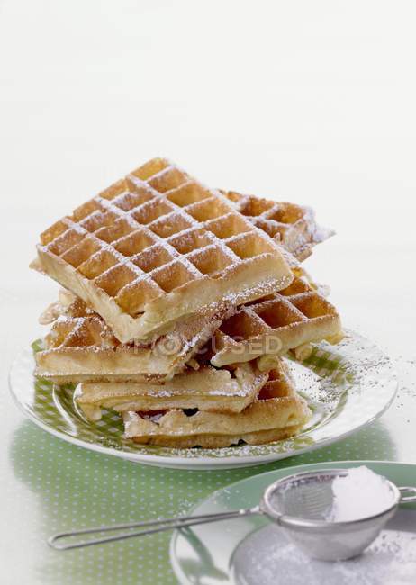Waffles dusted with icing sugar — Stock Photo