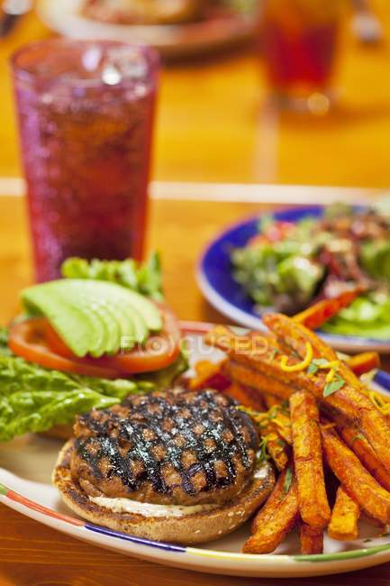 Grilled Turkey Burger with Sweet Potato Fried and a Soda — Stock Photo