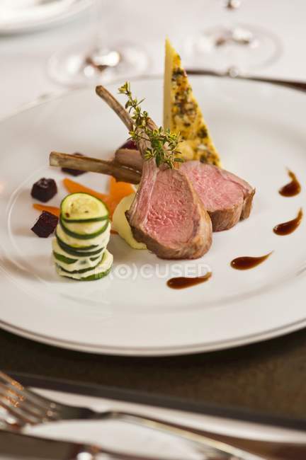 Lamb chops with courgette and pumpkin medley — Stock Photo