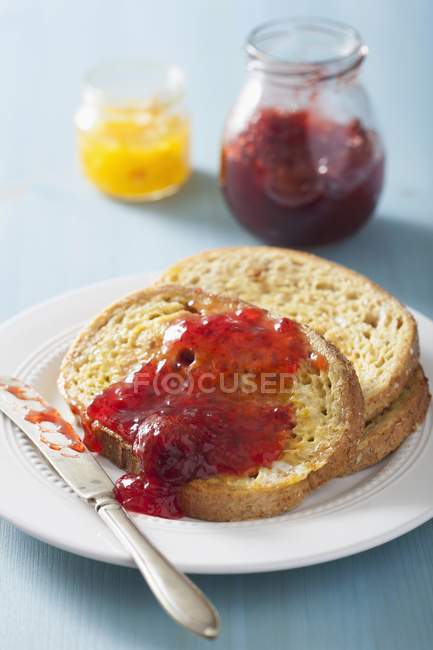 Closeup view of French toasts with strawberries and jam — Stock Photo