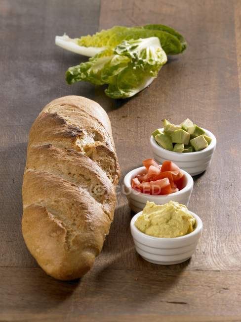 Ingredients for a baguette with avocado — Stock Photo