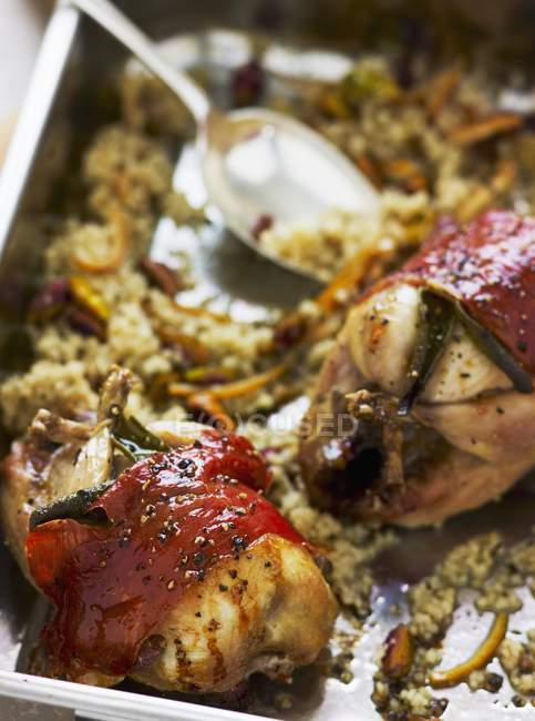 Closeup view of roast stuffed quails wrapped in bacon — Stock Photo