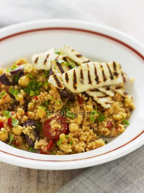 Couscous with chickpeas, chorizo and grilled haloum — Stock Photo