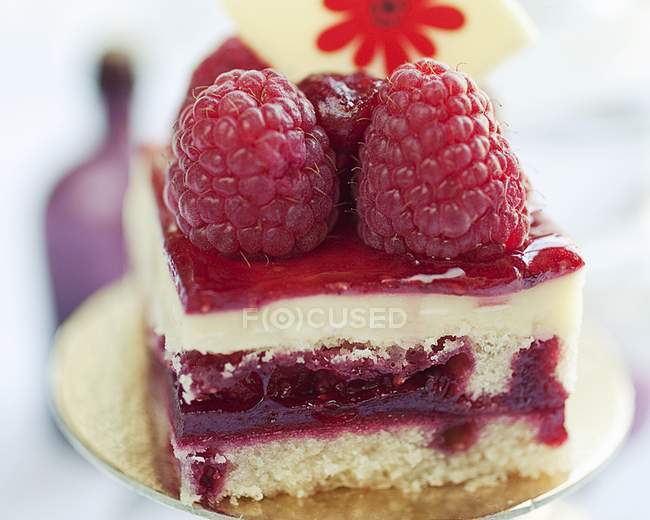 Closeup view of fruit cake with raspberries — Stock Photo