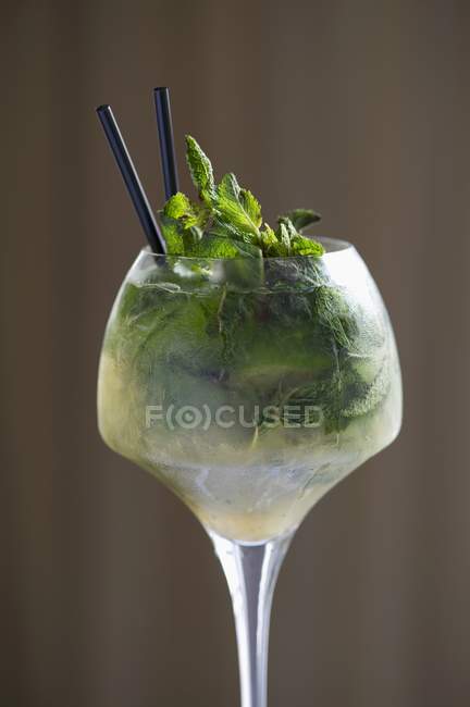 Mojito with mint in glass with cocktail straws — Stock Photo