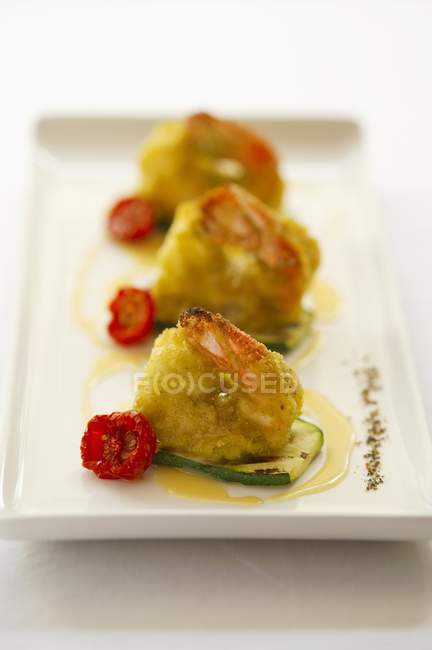 Battered king prawns with cherry tomatoes — Stock Photo