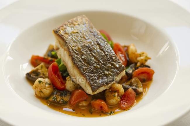 Sea bass fillet with tomatoes — Stock Photo