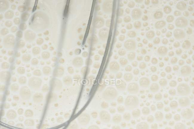 Closeup view of white batter and whisk — Stock Photo