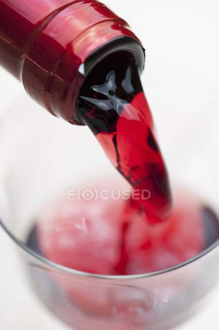 Pouring red wine into a glass — Stock Photo