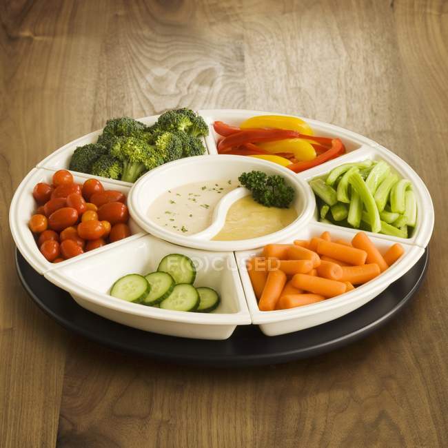 Veggie Platter with Two Dips over wooden surface — Stock Photo