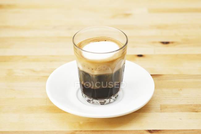 Espresso macchiato in glass cup — Stock Photo
