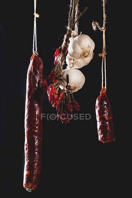 Hanging smoked sausages — Stock Photo