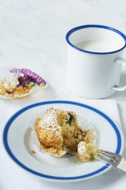 Blueberry muffin and cup of milk — Stock Photo
