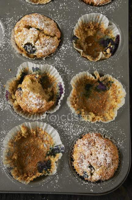 Half eaten tray of muffins — Stock Photo