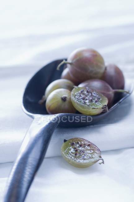 Fresh ripe Gooseberries on spoon — Stock Photo