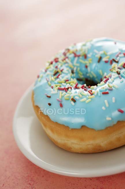 Blue-glazed doughnut with sugar sprinkles — Stock Photo