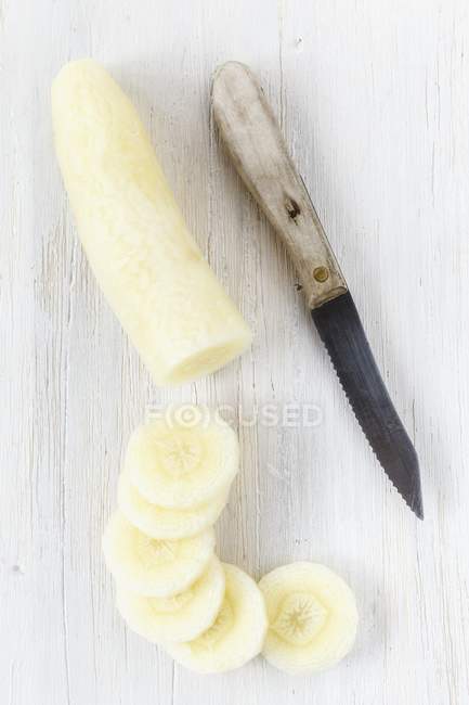 Partly sliced yellow carrot — Stock Photo