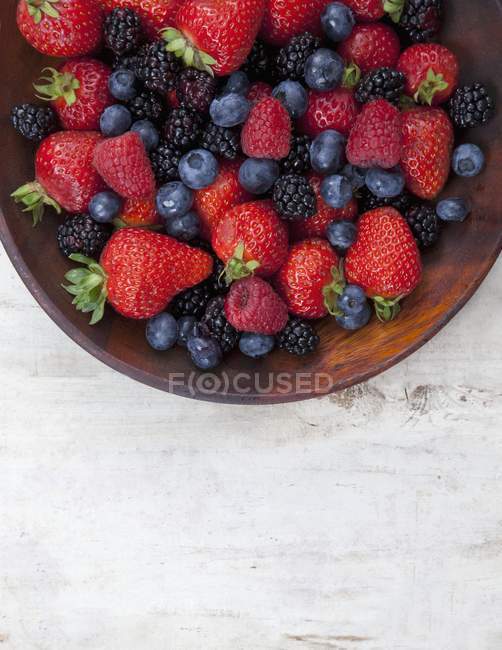 Mixed summer Berries in Wooden Bowl — Stock Photo