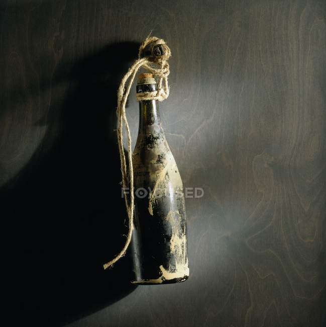 Top view of an antique wine bottle on a dark surface — Stock Photo
