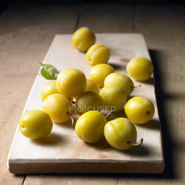 Mirabelles on a wooden board — Stock Photo