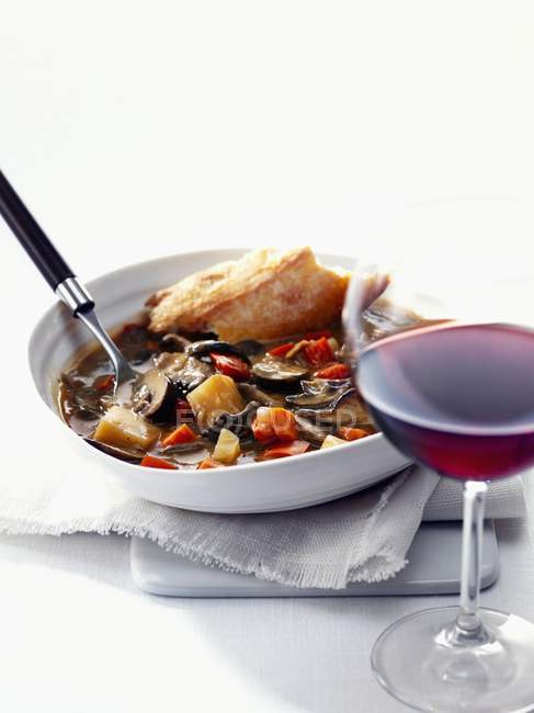 Mushrooms stew with baguette from Provence  on white plate over towel — Stock Photo