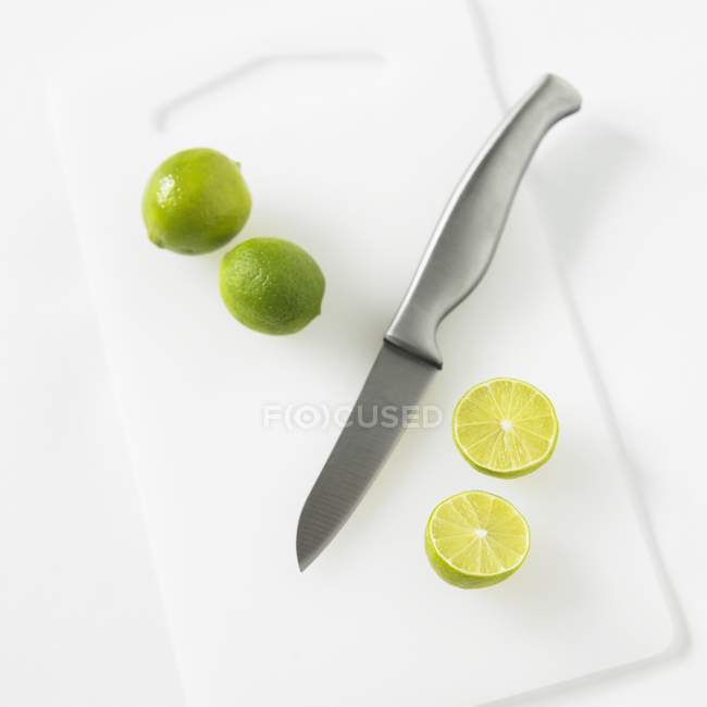Limes fraîches avec moitiés — Photo de stock