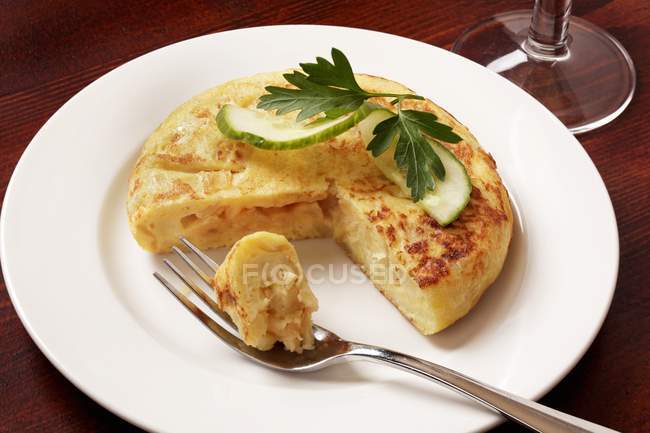 Cut potato Rosti on white plate with fork — Stock Photo