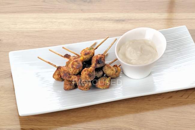 Elevated view of mini kebabs with a dip — Stock Photo