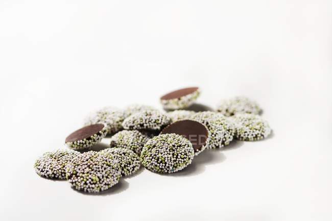 Closeup view of mint Nonpareils cookies on white surface — Stock Photo