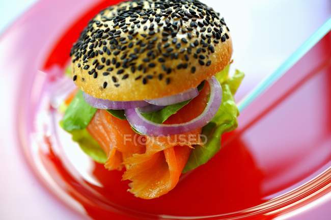 Poppyseed roll filled with salmon — Stock Photo