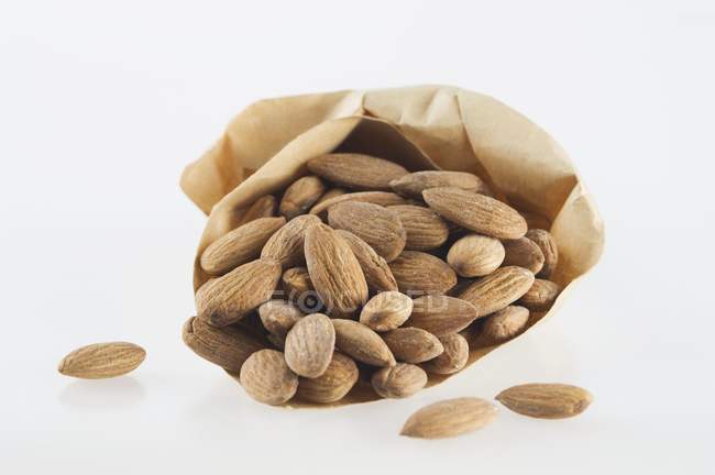 Almonds in paper bag — Stock Photo