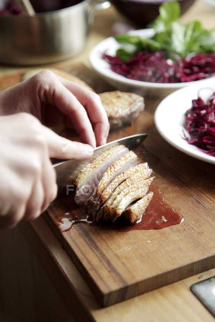 Hands cutting Roasted duck breast — Stock Photo