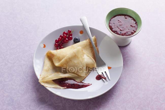 Crepes with berry sauce — Stock Photo